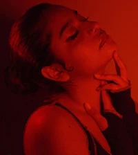 a woman posing with her hand on her chin